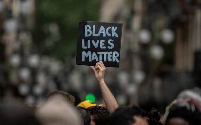 A protester holds up a \"Black Lives Matter\" sign.