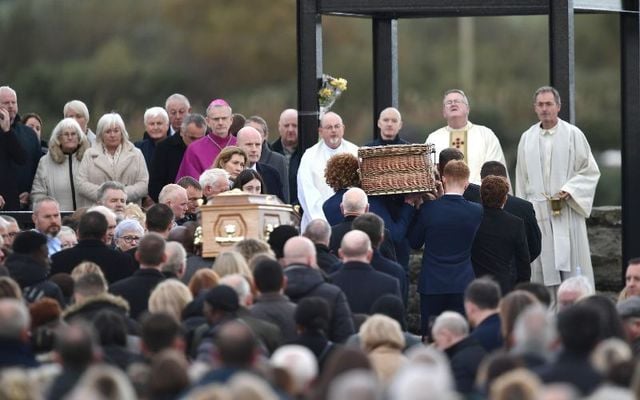 Family members carry Shauna Flanagan Garwe and her father Robert Garwe into St. Michael\'s Church on October 15. 