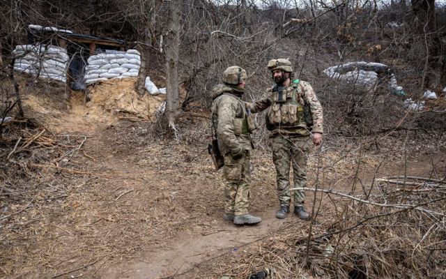 Ukrainian infantrymen with the 28th Brigade speak at their encampment near the frontline facing Russian troops on March 05, 2023, outside of Bakhmut, Ukraine. 