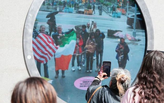 May 10, 2024: People in New York wave Irish and American flags to people in Dublin via The Portal, which was unveiled in both cities on May 8. 