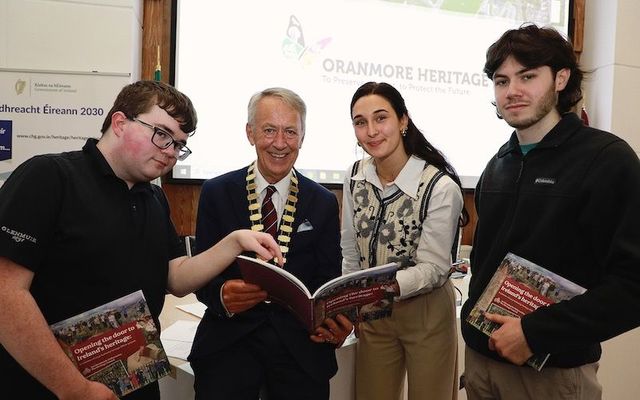 Cllr Liam Carroll, Cathaoirleach of the County of Galway and University of Galway students Dylan Reilly, Joseph Ennis and Natalie Cyrkle pictured with ‘Opening The Door To Ireland’s Heritage’, a Heritage Council publication which features their work on the ‘Galway County Heritage Trails’ project with Galway County Council. 