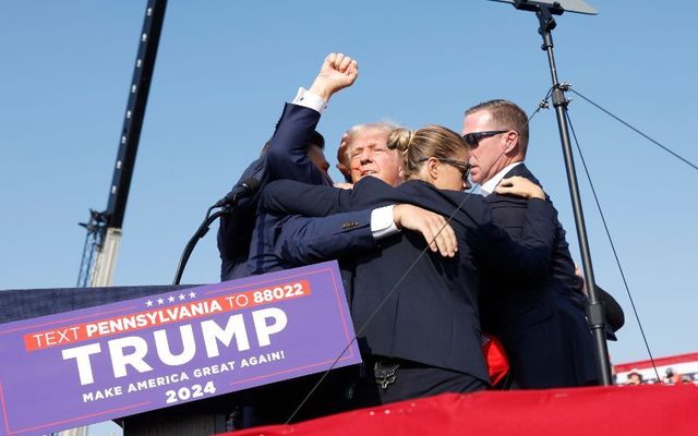 Trump raises his fist after surviving an assassination attempt in Pennsylvania on Saturday evening. 