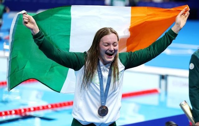 July 29, 2024: Bronze Medalist Mona McSharry of Team Republic of Ireland poses with the national flag following the Swimming medal ceremony after the Women’s 100m Breaststroke Final on day three of the Olympic Games Paris 2024 at Paris La Defense Arena in Nanterre, France.