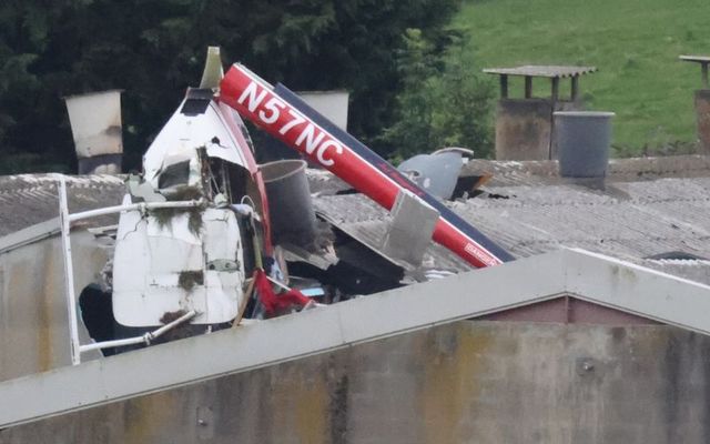 July 30, 2024: The wreckage of the helicopter seen above the roof of the building into which it crashed in Kilucan, Co Westmeath.