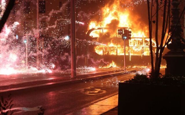 November 23, 2023: A double-decker bus and a car set alight on the edge of Dublin\'s O\'Connell Bridge people riot on O\'Connell Street and surrounding areas of Dublin City Center.