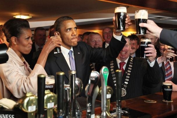 Michelle and Barack Obama enjoying a pint in Moneygall, County Offaly, during their 2011 visit.