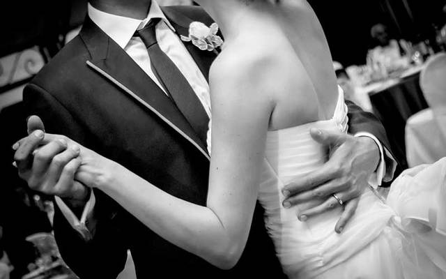 A bride and groom dancing.