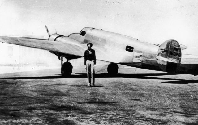 Amelia Earhart with her plane Electra, circa 1937.