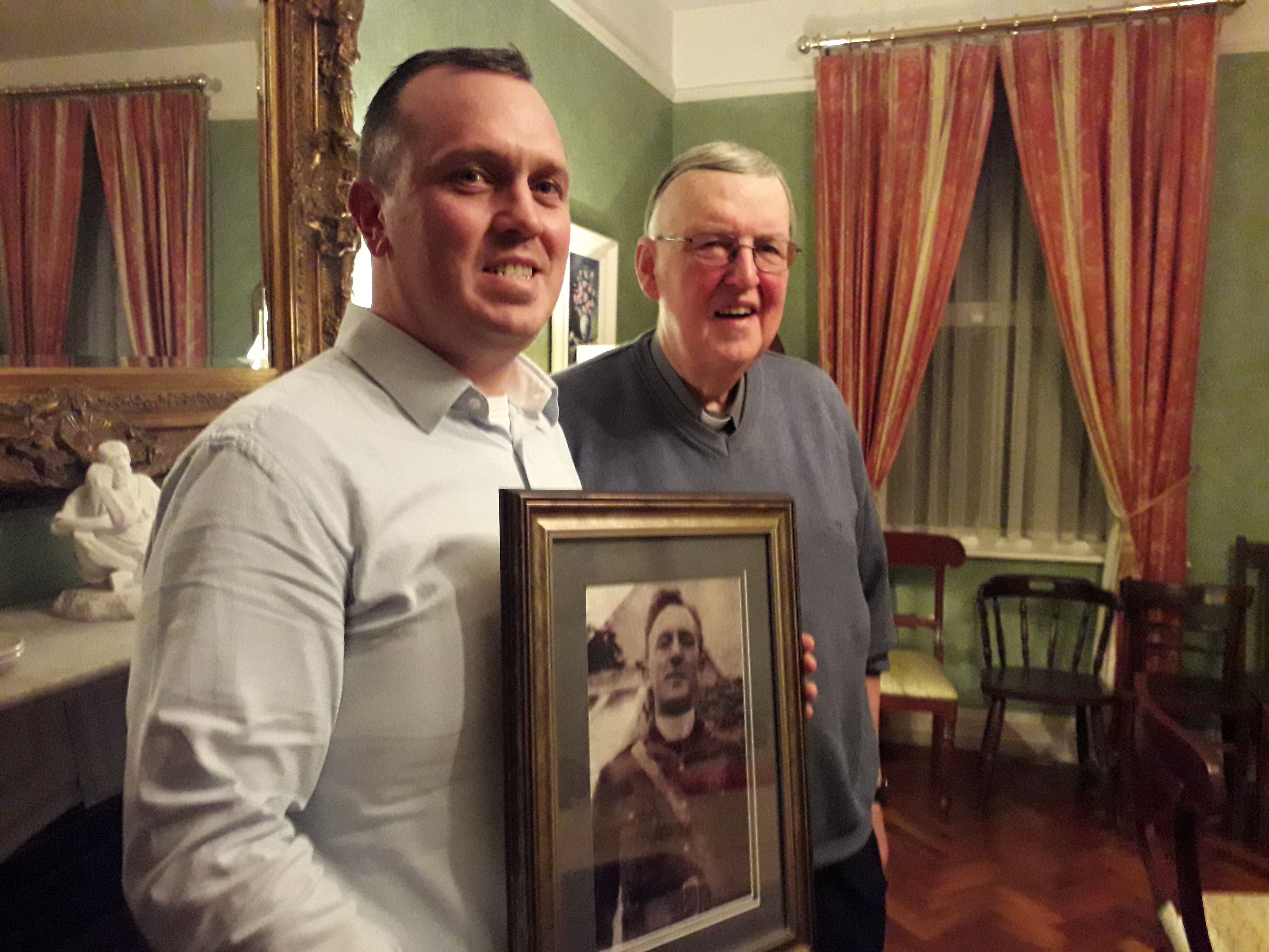 John Connolly and Fr Martin Downey, with a photo of Fr Griffin, courtesy of Ciaran Tierney Digital Storyteller.