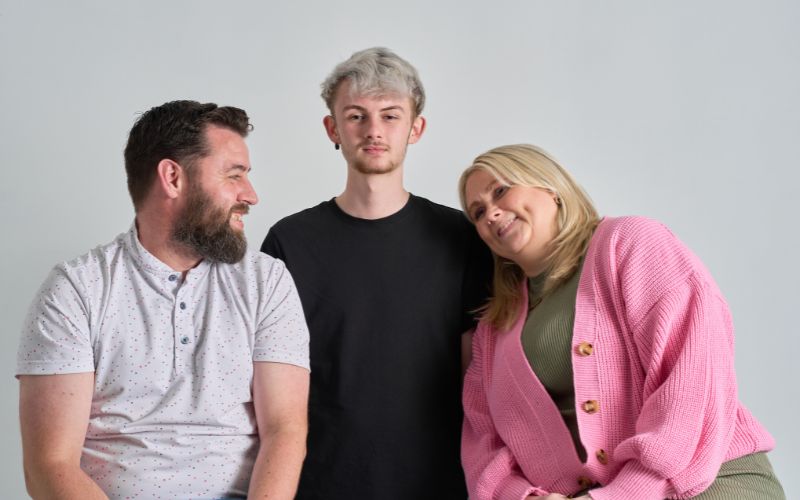 Josh, center, with his parents. (RTE)